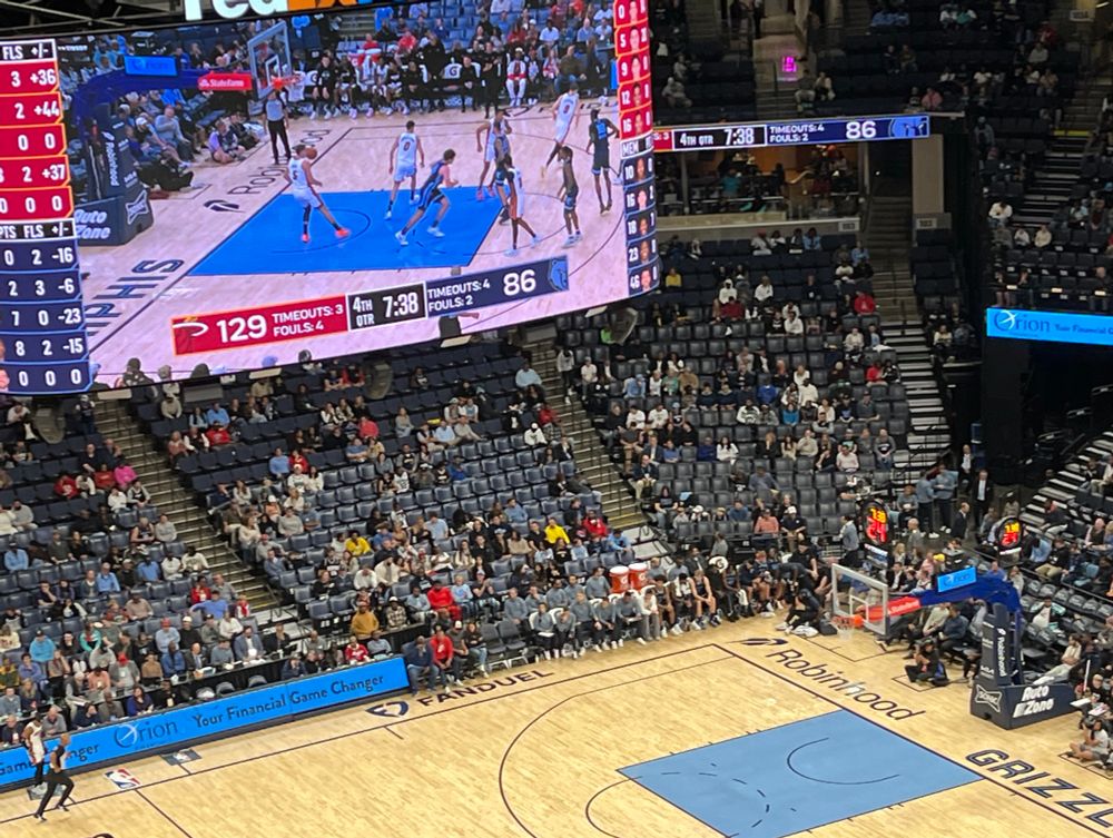 Basketball court with the arena scoreboard showing Miami Heat 129 & Memphis Grizzlies 86
