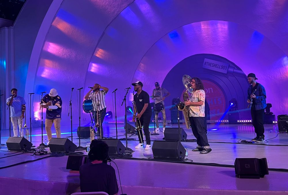 Same musicians on stage, though it’s now dark out & the stage is lit up purple