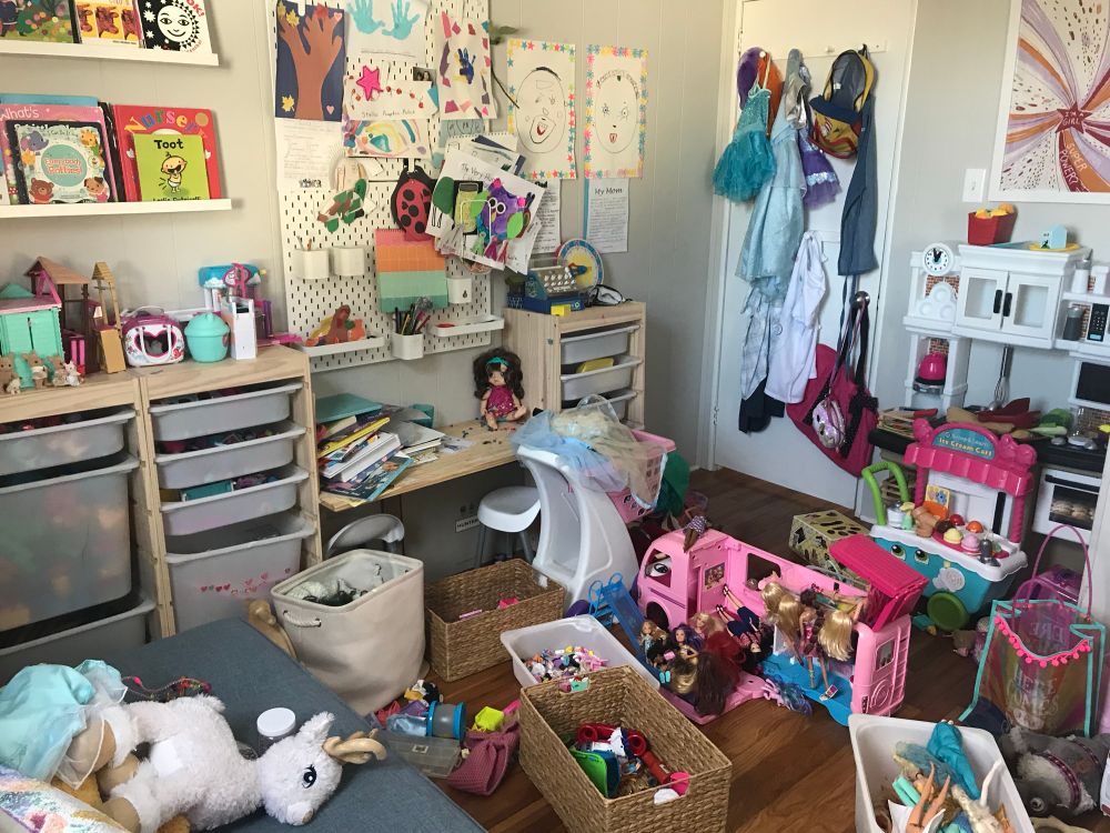 Kids playroom with toys artwork and books