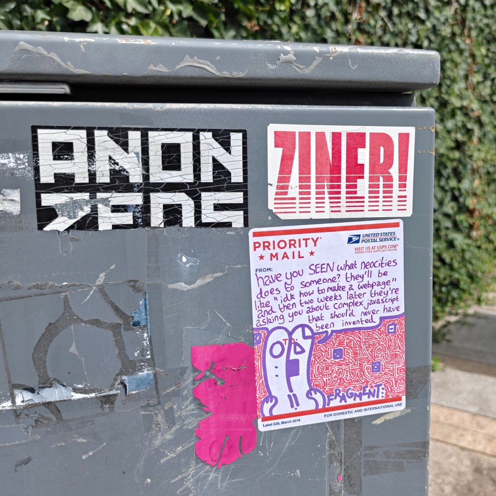 Stickers on an electrical box  At the top are two nametags for ANONZEDS and ZINER!. Below it is a fragment sticker featuring a rabbit surrounded by floating computer icons and a red patterned background, saying "have you SEEN what neocities does to someone? they'll be like "idk how to make a webpage" and then two weeks lager they're asking hoi about complex jacascript that should never have been invented".
