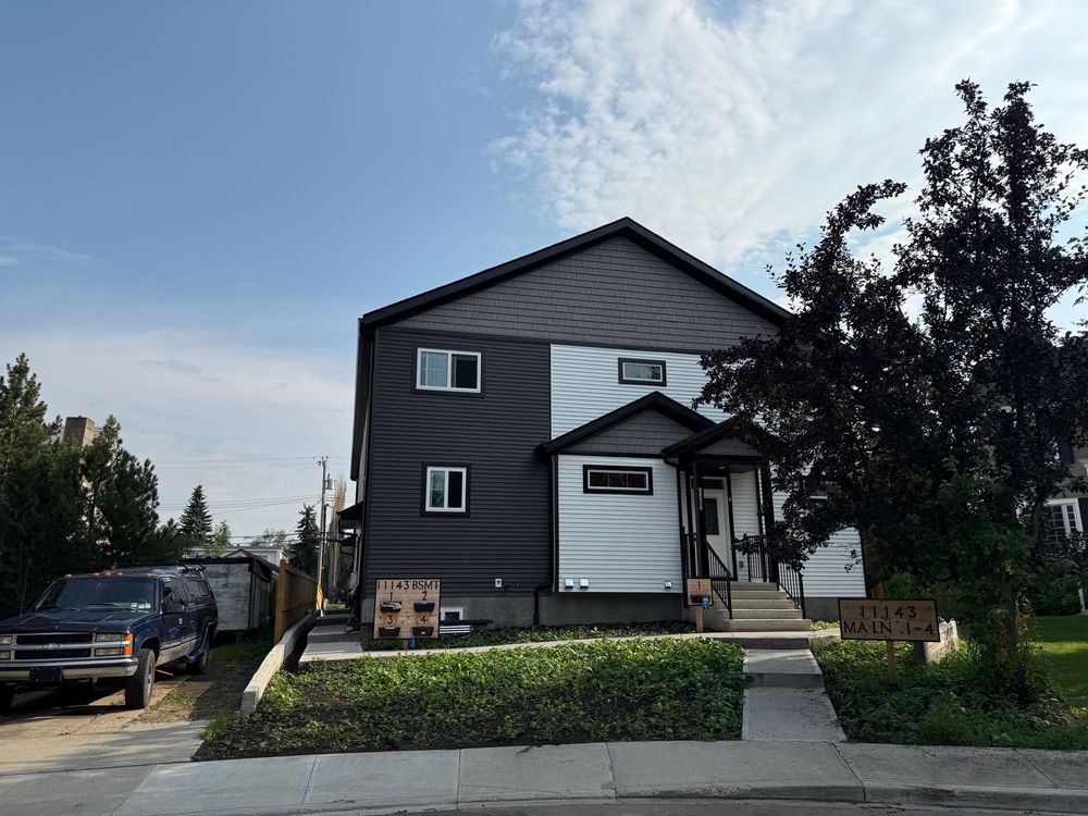 The front of a new infill development with another home beside it.