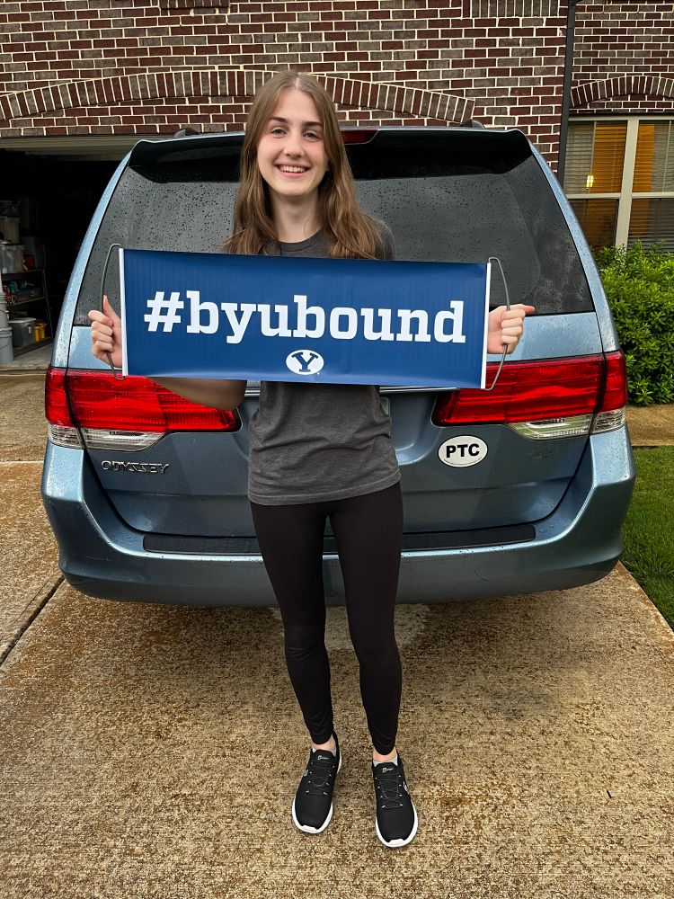 Kid holding a #byubound sign