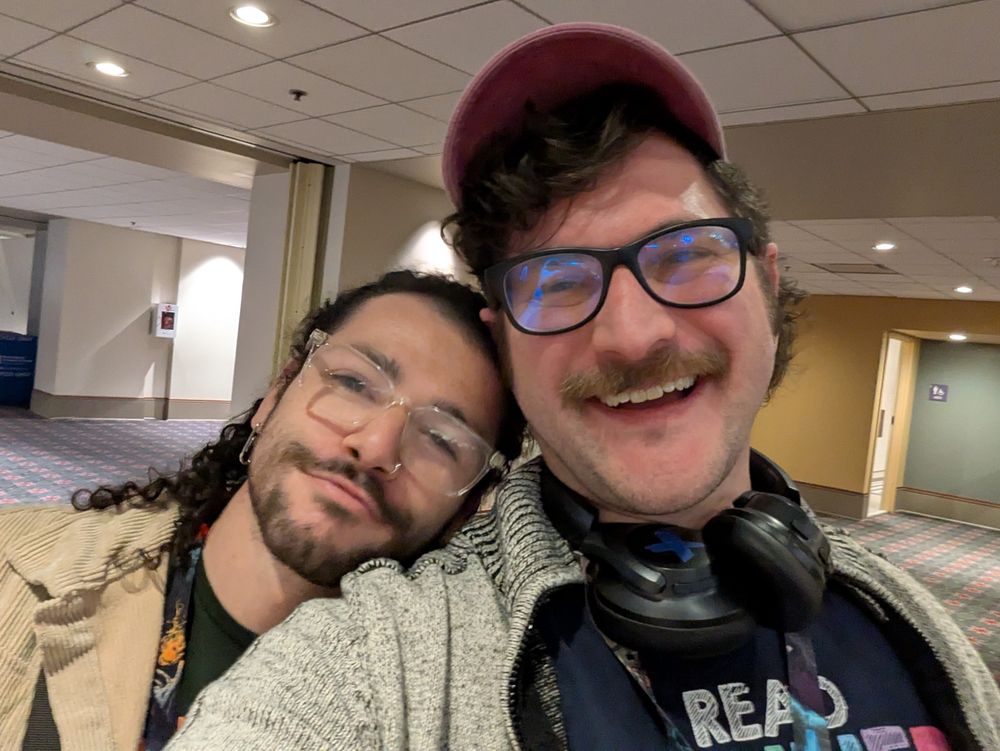 Bauhaus and Tophie smiling into the camera together 