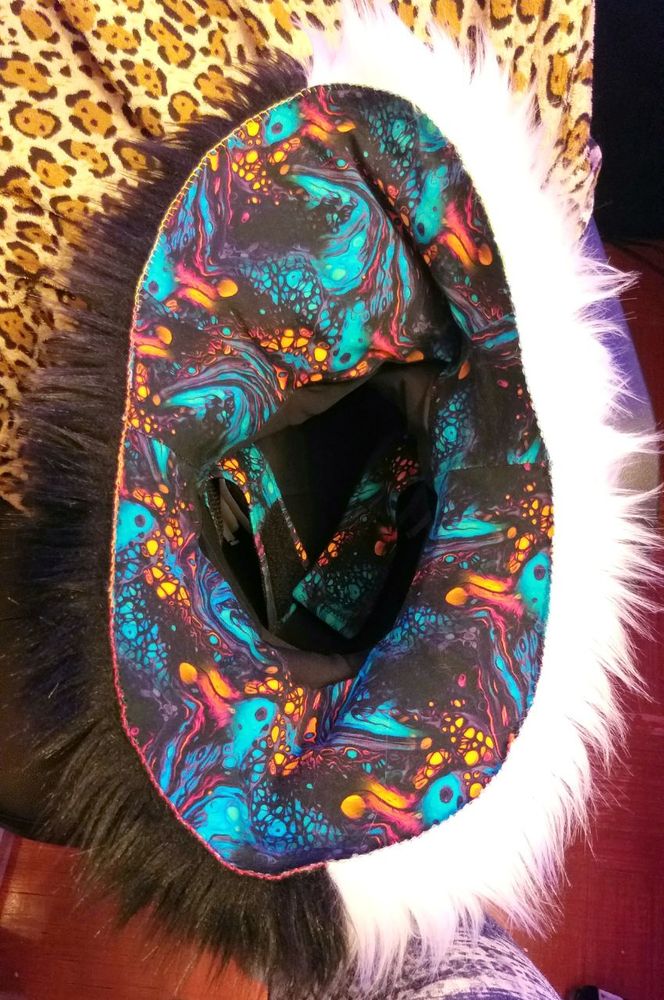 Inside lining of the fursuit head. The neck lining is a patterned fabric that has pockets in the front and the back. Inside the head is a carefully fitted black lycra, and velcro-adjustable head strap. Despite no zipper, it is very easy to put on.