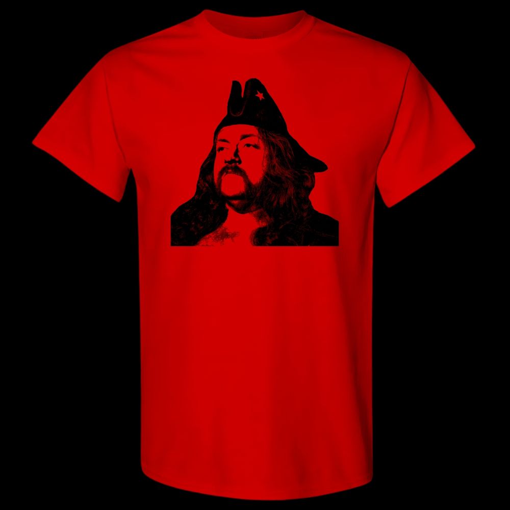 A bearded pirate with long hair in silhouette with a red star on his pirate hat, on a red t-shirt, boldly or potentially boredly looking off to the left hand side of the image.