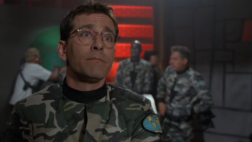 Scene from the "Stargate: SG-1" episode "200." The real-life actor Christian Bocher, appearing as himself, addresses an off-screen interviewer, explaining that he (the real-world person) is portraying an actor playing a role based on another role played by two other real-life actors.