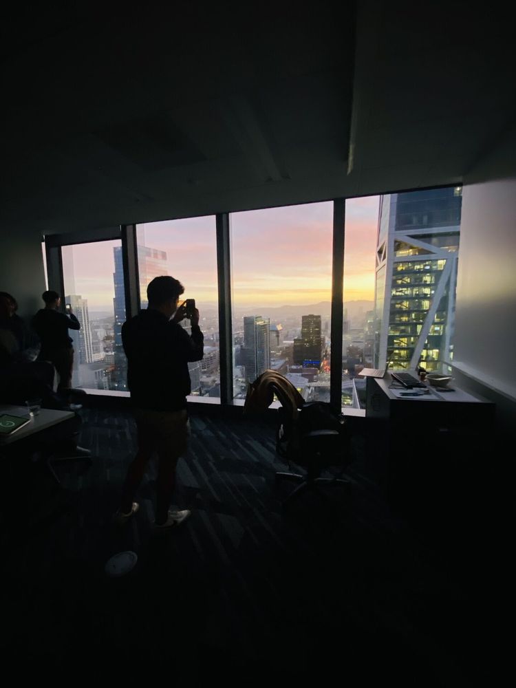 Photo by Peter Cottle on June 04, 2025. May be an image of 3 people, skyscraper, twilight, buildings and text.