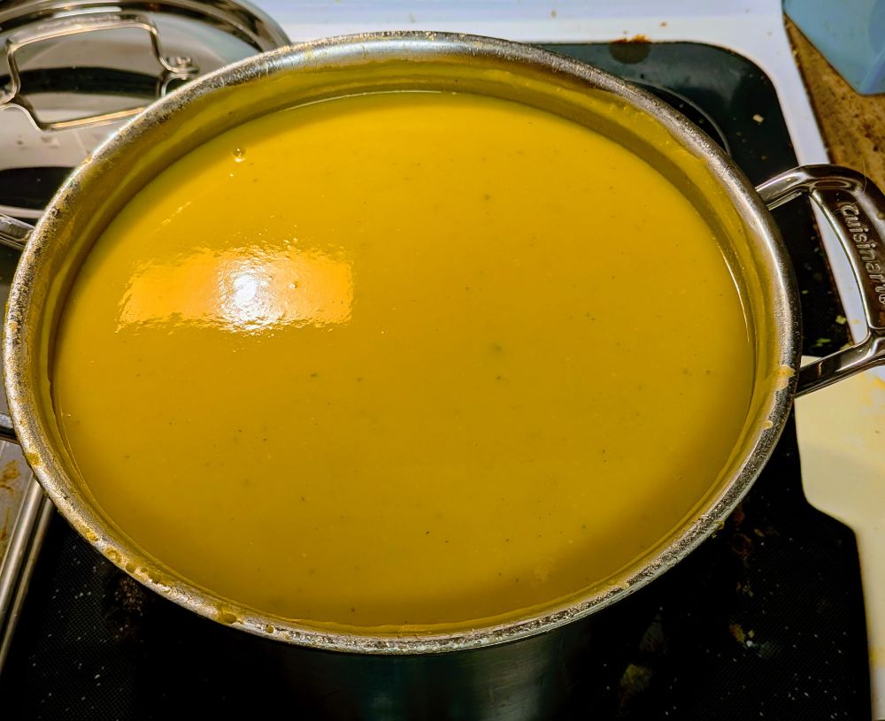 A large stock pot full of squash soup 
