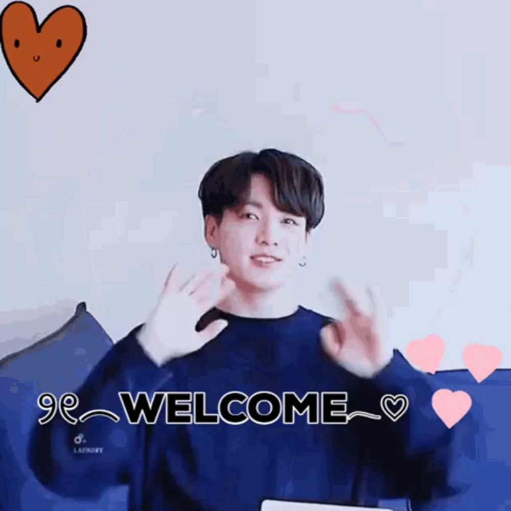 a boy wearing a blue sweater with the words welcome written on it