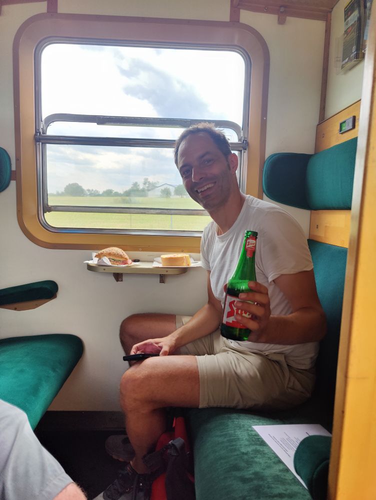 Jon Worth holding up a beer