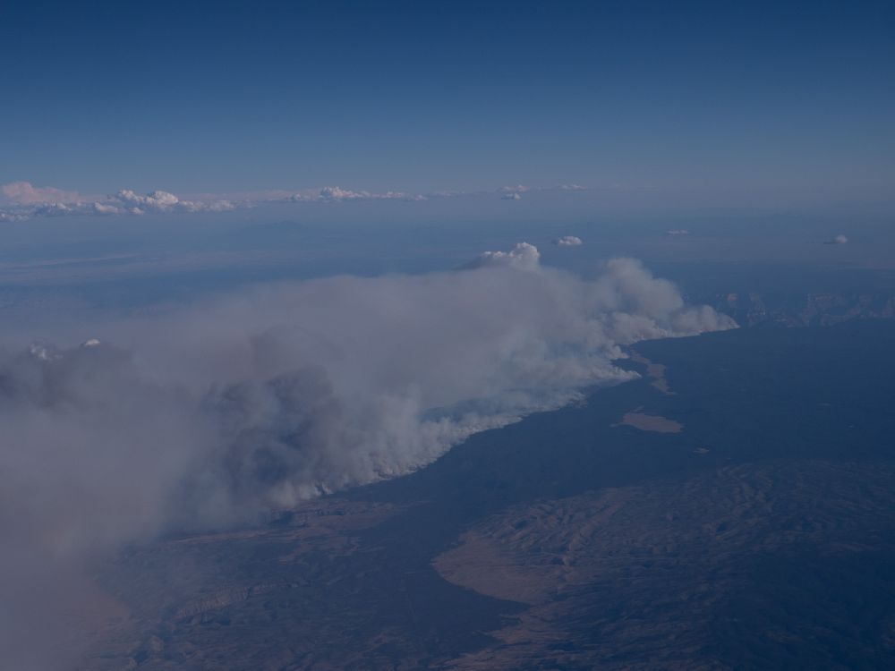 Overview shot of the Bravo Dragon fire. In the upper right half of the photo you can see the grand canyon. It is dwarfed by the fire, which runs for miles and miles. 