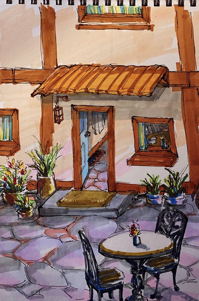 drawing of a patio, with a small circular table, and two chairs set on it. there are potted plants near the door and a small awning on top of it. a door mat is set before the door's entrance.
