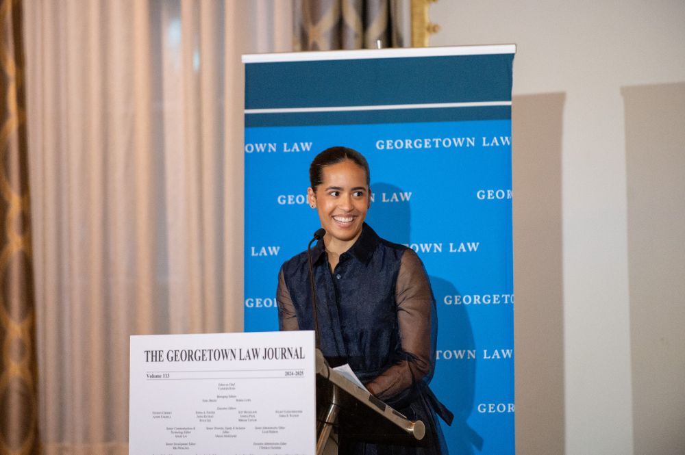 Outgoing Editor-in-Chief Yasmeen Rose smiles at the podium while delivering remarks at the Georgetown Law Journal banquet. The Georgetown Law logo is visible in the background