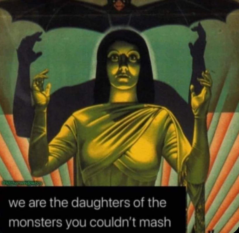 A glowing woman with raised hands and a bat-like shadow behind her. Text at the bottom says, "we are the daughters of the monsters you couldn't mash."