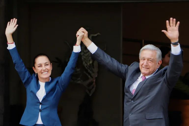 Mexico's ex-President Andres Manuel Lopez Obrador and current president Claudia Sheinbaum gesture after Sheinbaum arrived at the National Palace for a meeting, in Mexico City, Mexico, on June 10, 2024