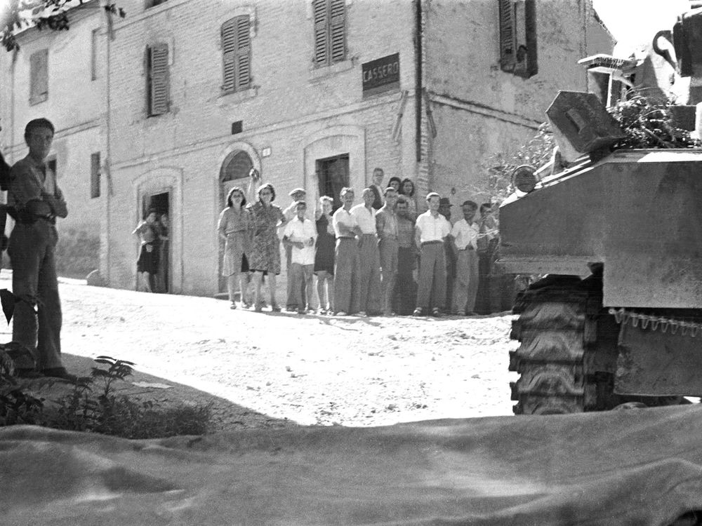 People looking at a tank in my tiny hometown in rural Italy, July 1944 