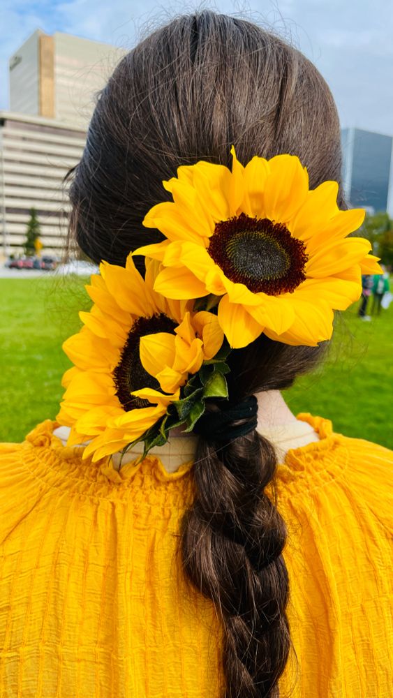 Sunflowers in the hair of a protester for Ukraine in Anchorage, Alaska