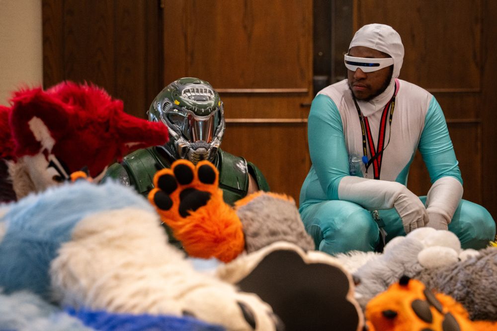photo of frozone and doom guy cosplayers hanging out at the furpile