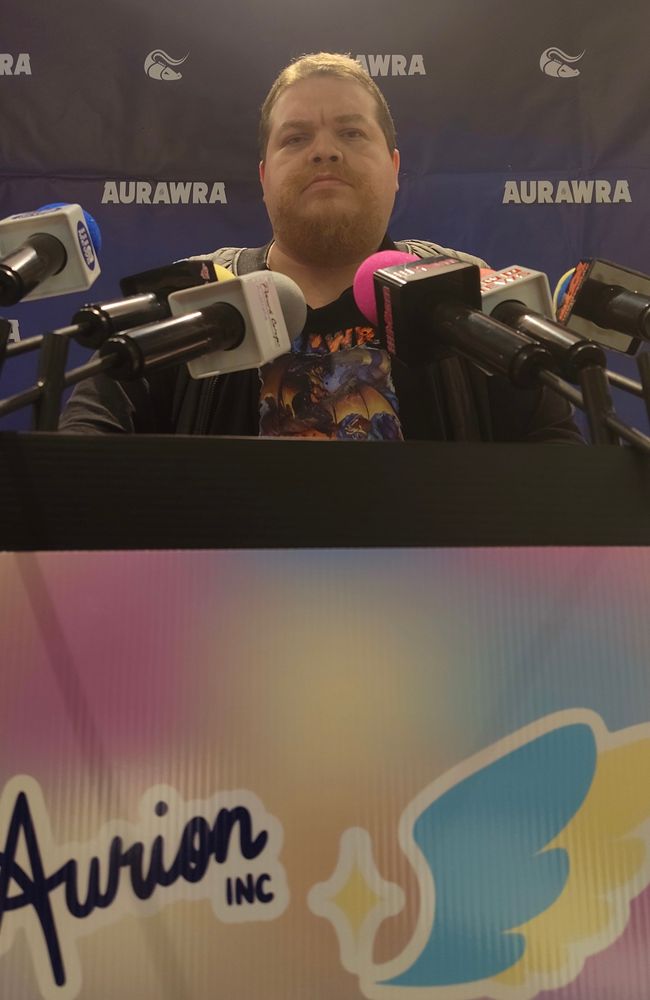 really serious johari behind a podium with microphones