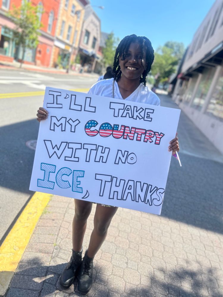 Protester with sign: “I’ll take my country with no ICE, thanks.”