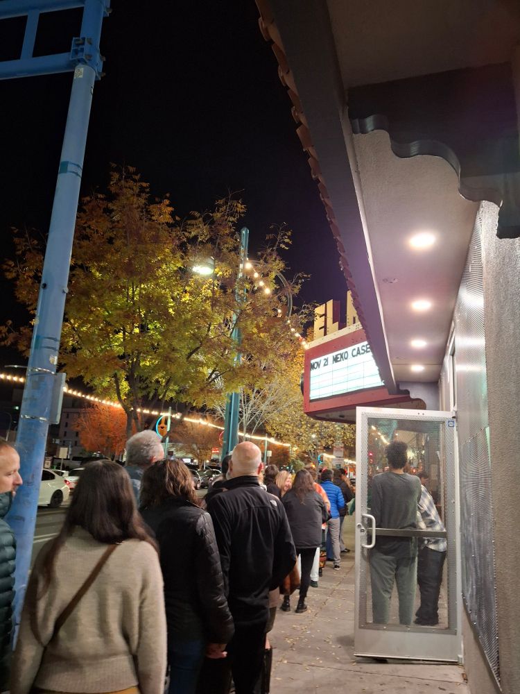 Marquee of the El Rey Theater in Abq reads NOV 21 NEKO CASE. The backs of people waiting to go in. 