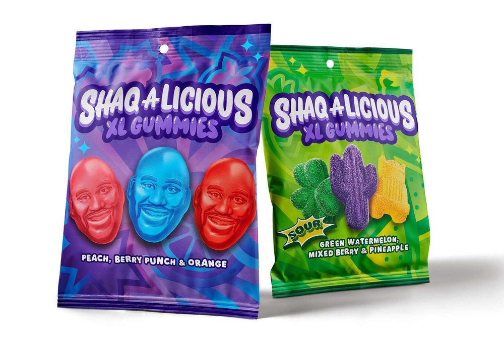 picture of two packages of Shaq-A-Licious XL Gummies, normal and sour. The normal ones are in a purple package and are shaped like Shaq's face. The sour ones are in a bright green package and are shaped like a shamrock, a cactus, and a truck.