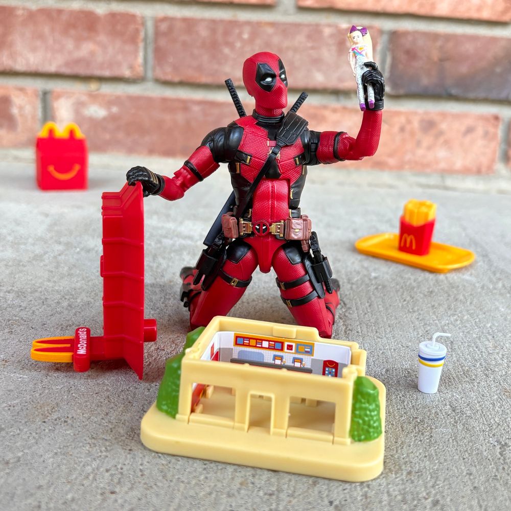 Marvel Legends Deadpool plays with Happy Meal Mini McDonald’s toys.