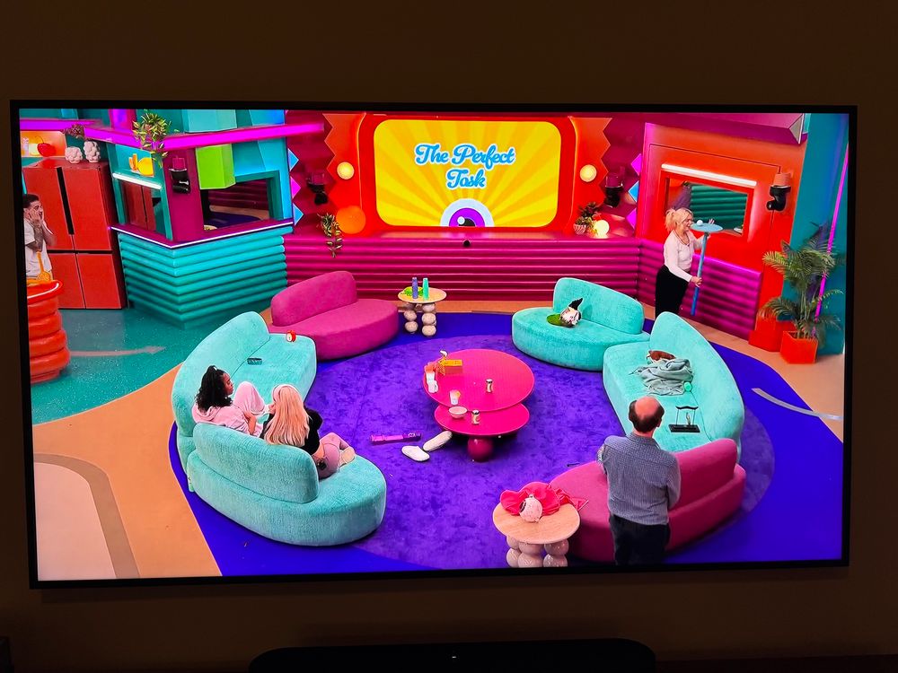 Jenny balancing a ball on a podium through the living room.