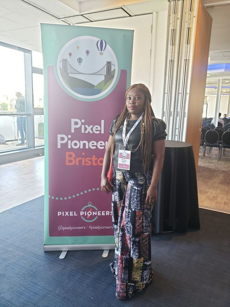 One of the recipients of the Pixel Pioneers diversity scholarships in front of a Pixel Pioneers banner