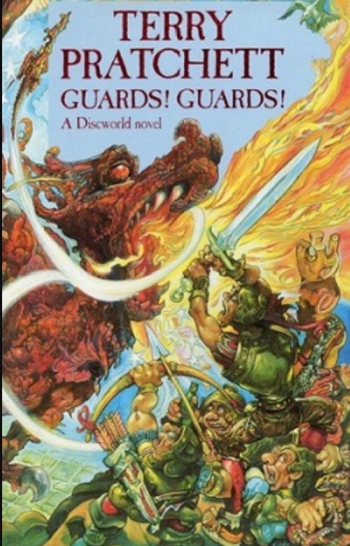 A book cover for Terry Pratchett's Discworld novel Guards! Guards! which introduces readers to Sam Vimes and the Ankh Morpork City watch. The cover shows a dragon breathing fire while several men in guard uniforms cower in the corner. One has a bow, another has a sword. They are huddled around a statue of a king. 