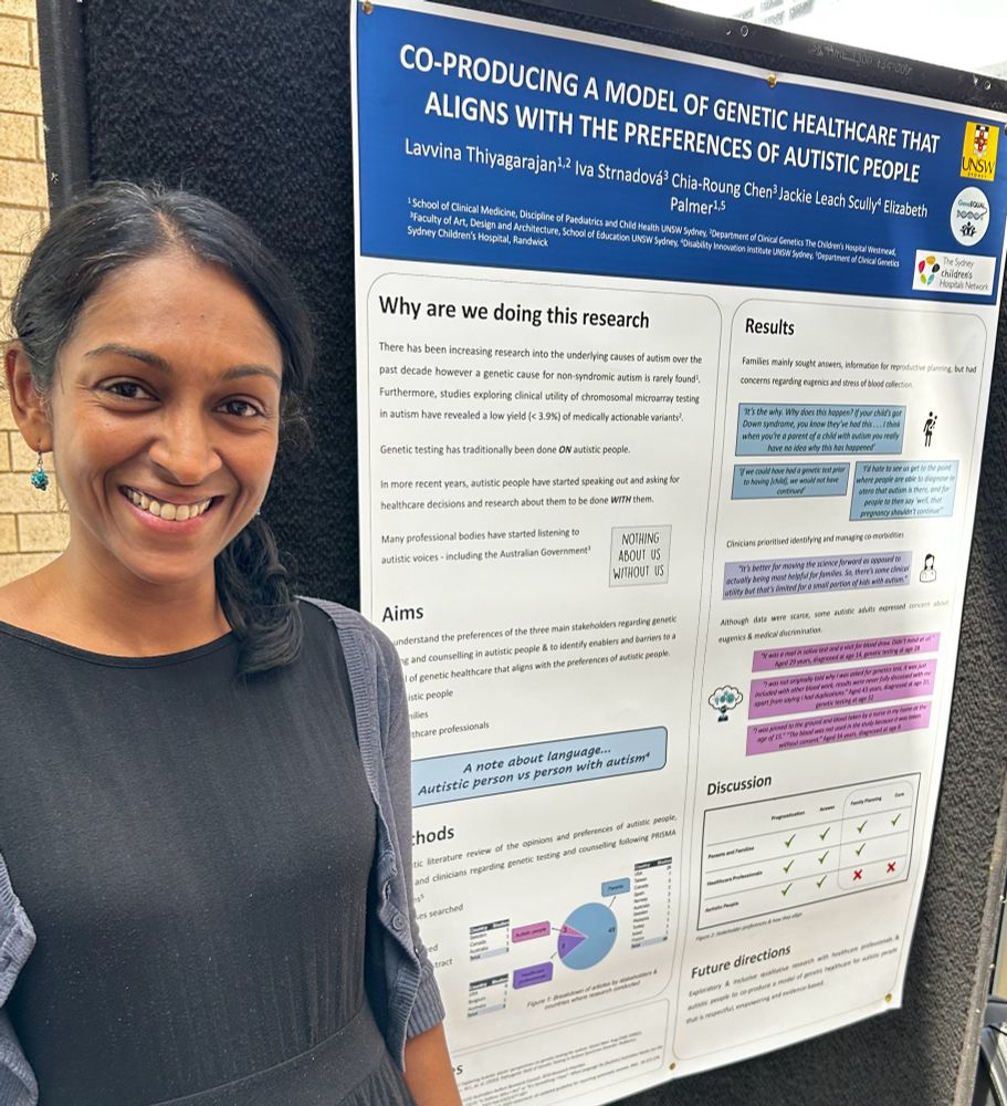 A doctor standing next to her brilliant poster 
