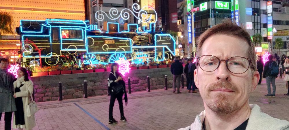 Night photo of the steam locomotive that inexplicably sits outside Shinbashi station