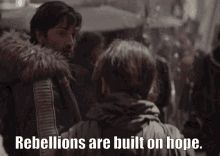 Cassian Andor and Jyn Erso from Star Wars : Rogue One. He is telling her - Rebellions are built on hope.

