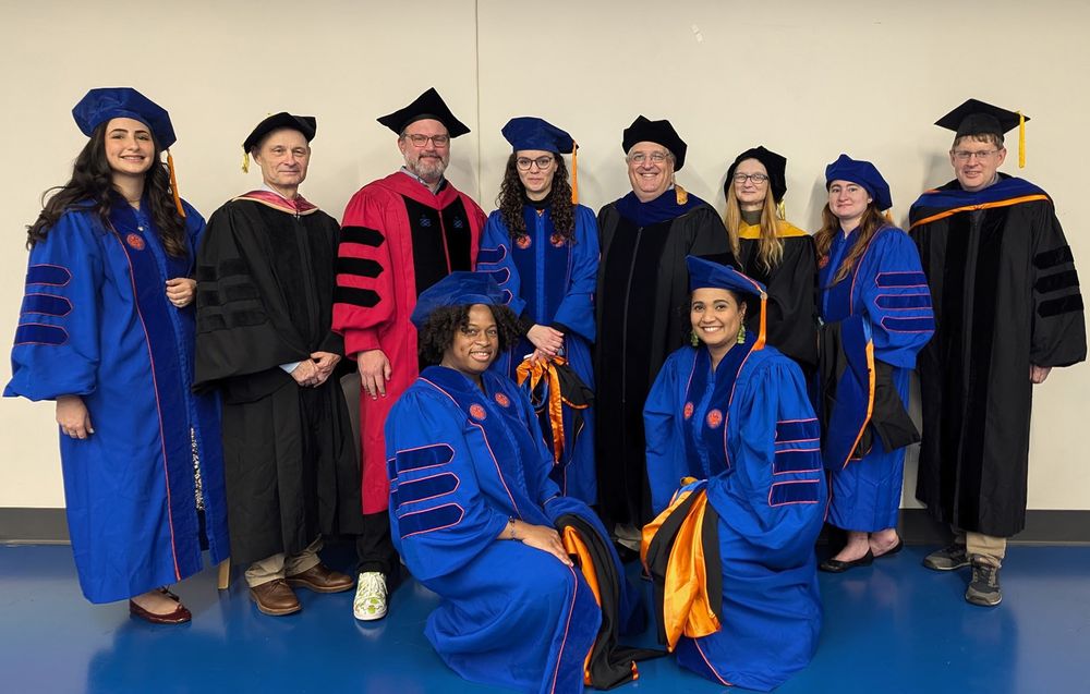 a group of people are wearing a variety of formal university graduation caps and gowns