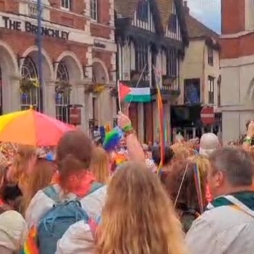A small Palestine flag is held in my hand, high above the crowd in a busy Jubilee Square outside the Maidstone Town Hall
