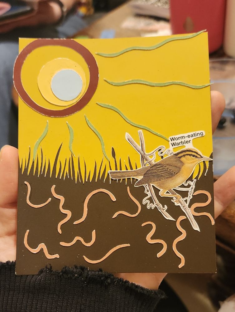 Worm Eating Warbler on top of a grassy golden background, brown on the bottom half with worms squirming around, above is a red-gold-light blue sun looking toward the warbler with green rays across the gold sky.