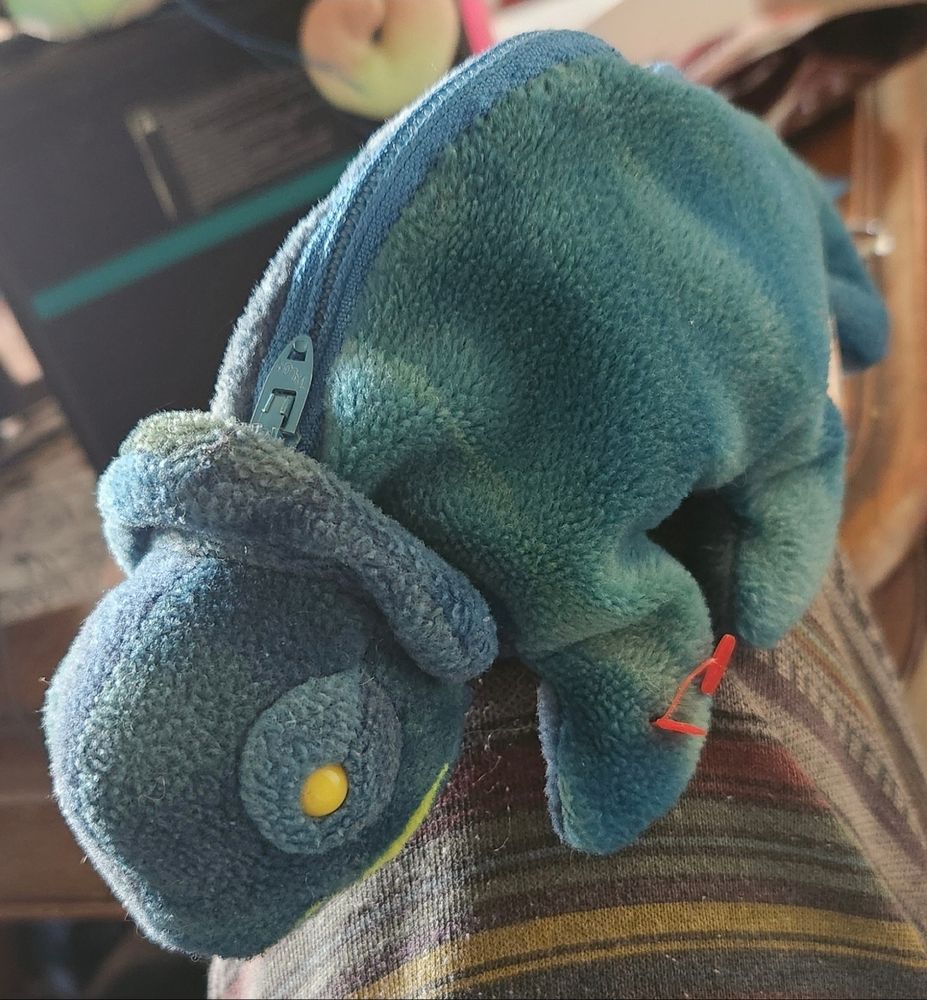 A green tiedye beanie baby chamileon with a zipper across it's back