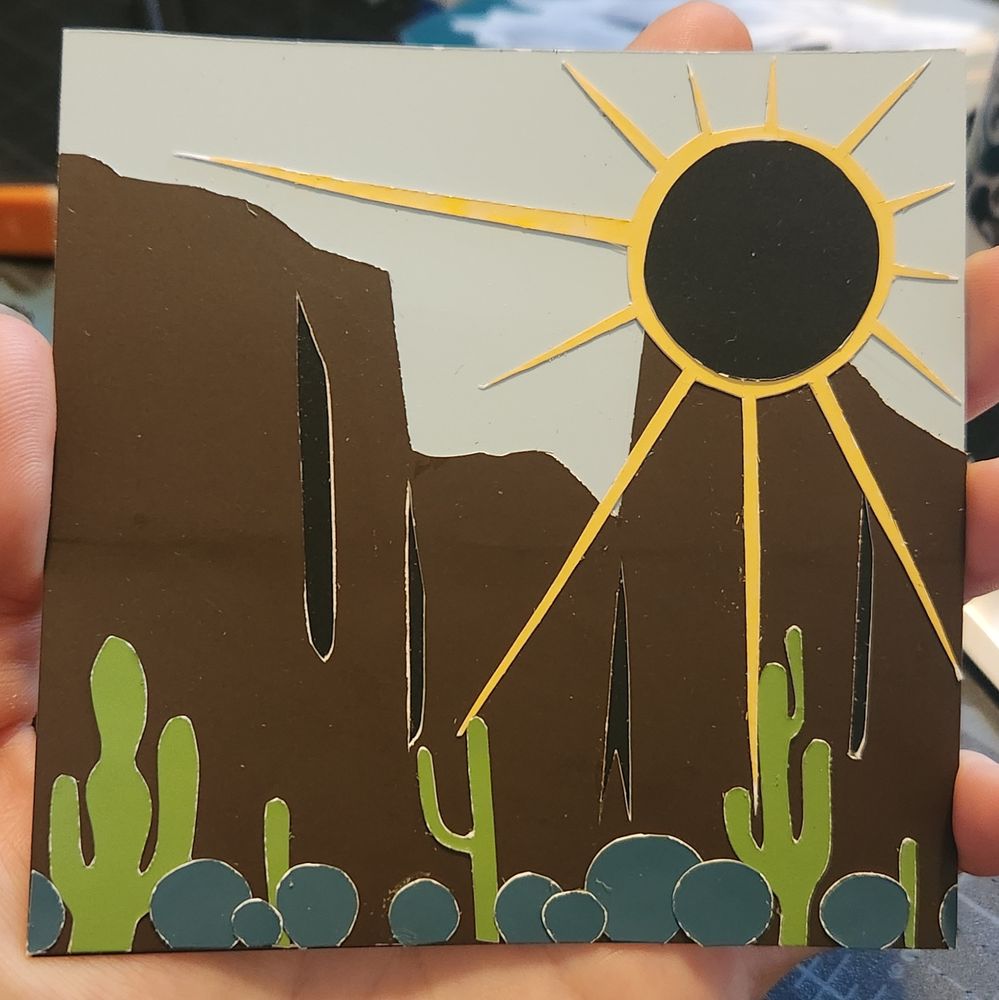 Collaged cliff face landscape, an eclipsing sun with Saguaro and barrel cacti in the foreground 