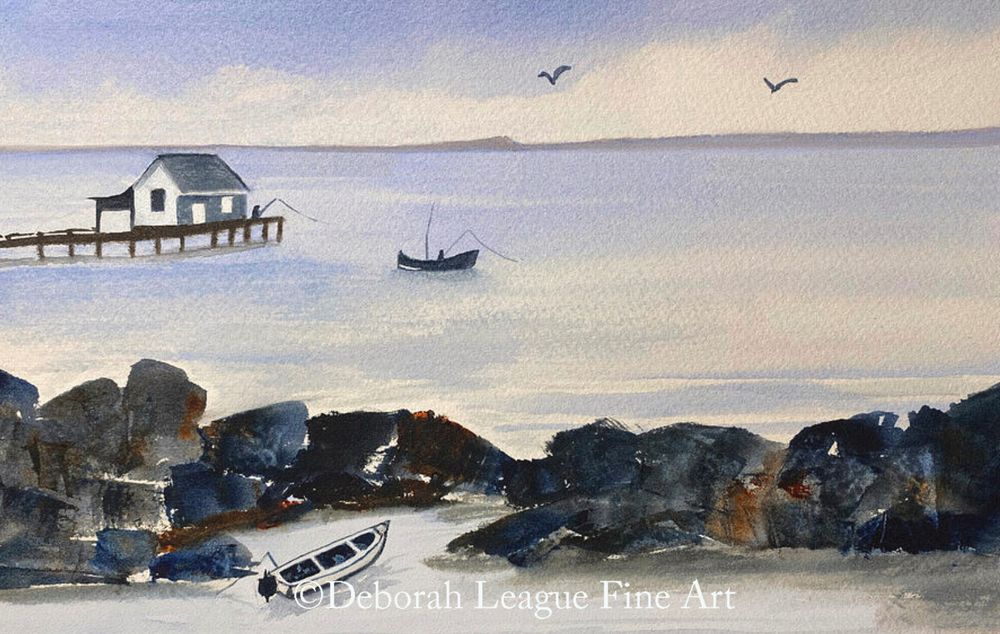 A serene coastal scene is depicted, with a small house perched on a pier extending into tranquil waters, where two boats are gently floating. Dark rocks in the foreground form a sea wall and contrast the softer shades of the blues and grays used for the sky and sea, while two birds soar in the distance, enhancing the sense of peacefulness. Someone fishes from the boat mid canvas, and another person fishes from the pier.