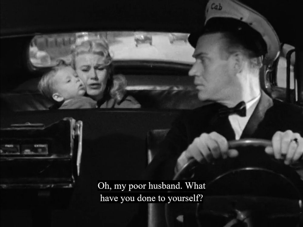 Black and white film still of Ginger Rogers in the backseat of a taxi hugging a toddler; a caption reads: "Oh, my poor husband. What have you done to yourself?"