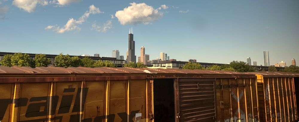 Sears Tower and Chicago skyline with boxcar train in foreground on a sunny summer day. 2024 by William L. Domme