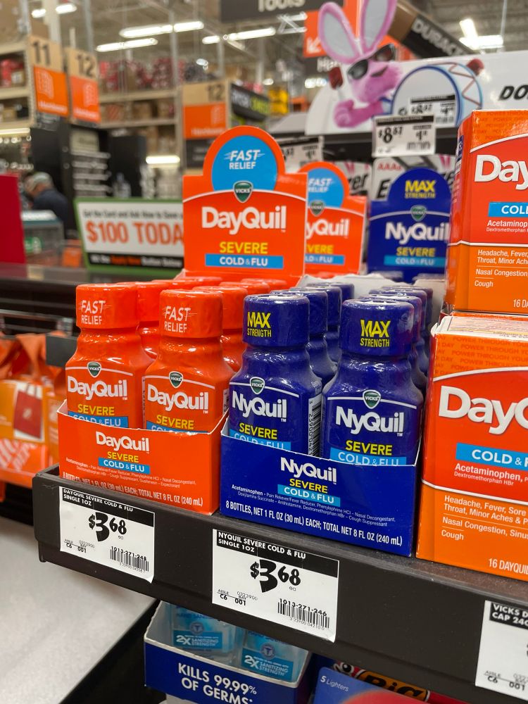 A display of NyQuil and DayQuil in 5 hour energy style bottles 