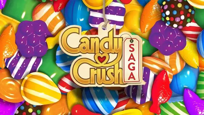 Candy Crush Saga logo on background of coloured sweets