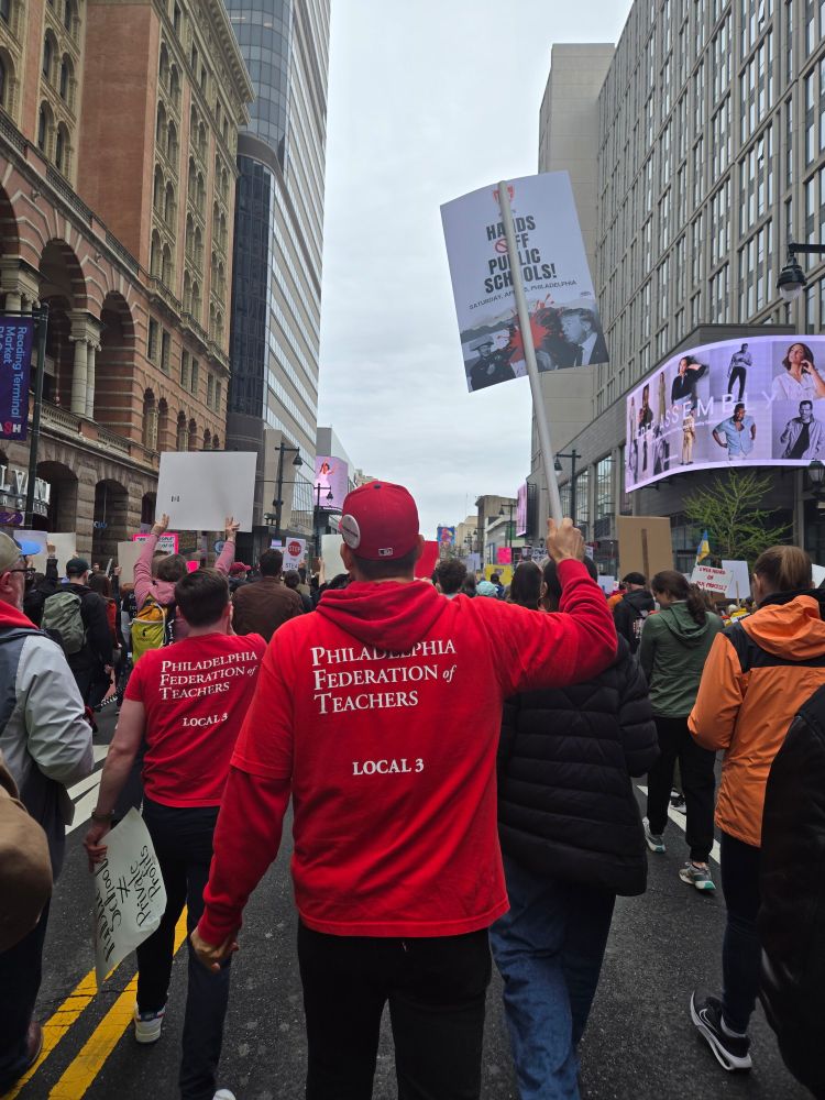 Photo of a group of Philadelphia Federation of Teachers marching down Market Street in Philadelphia wearing red shirts that say "Philadelphia Federation of Teachers"