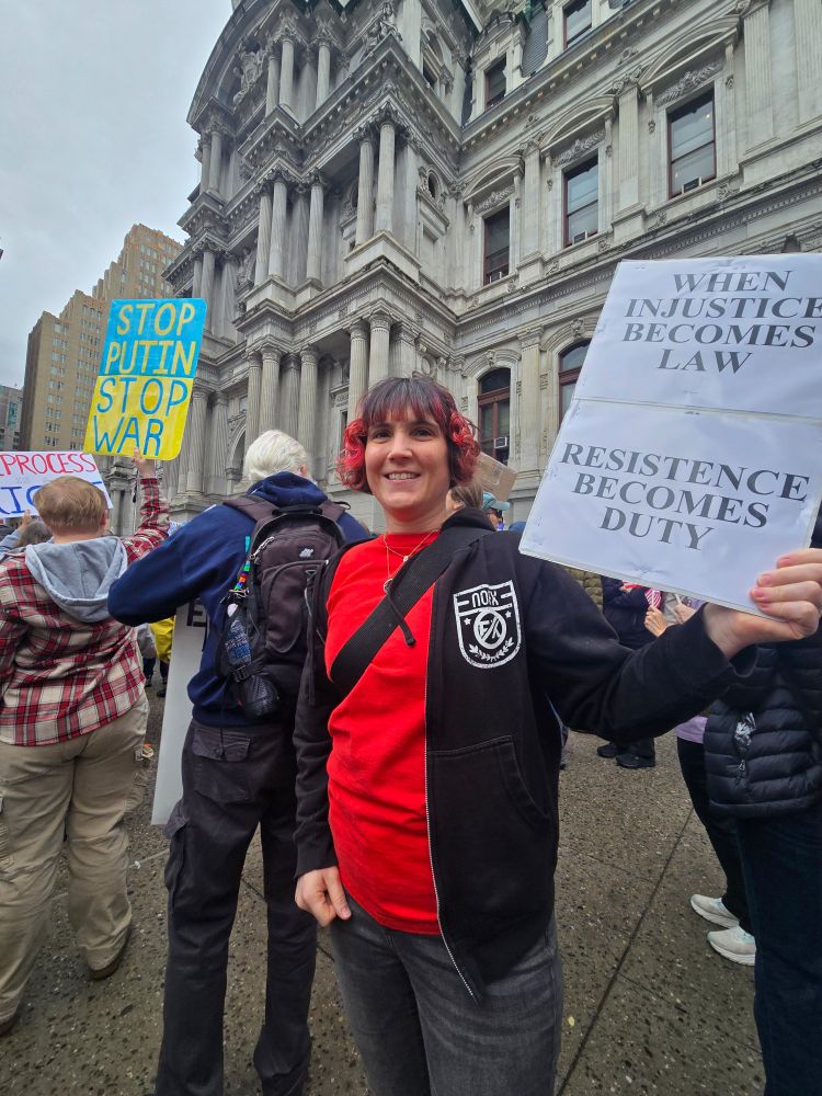 Protester holding up a sign that says "When injustice becomes law, resistance becomes duty."