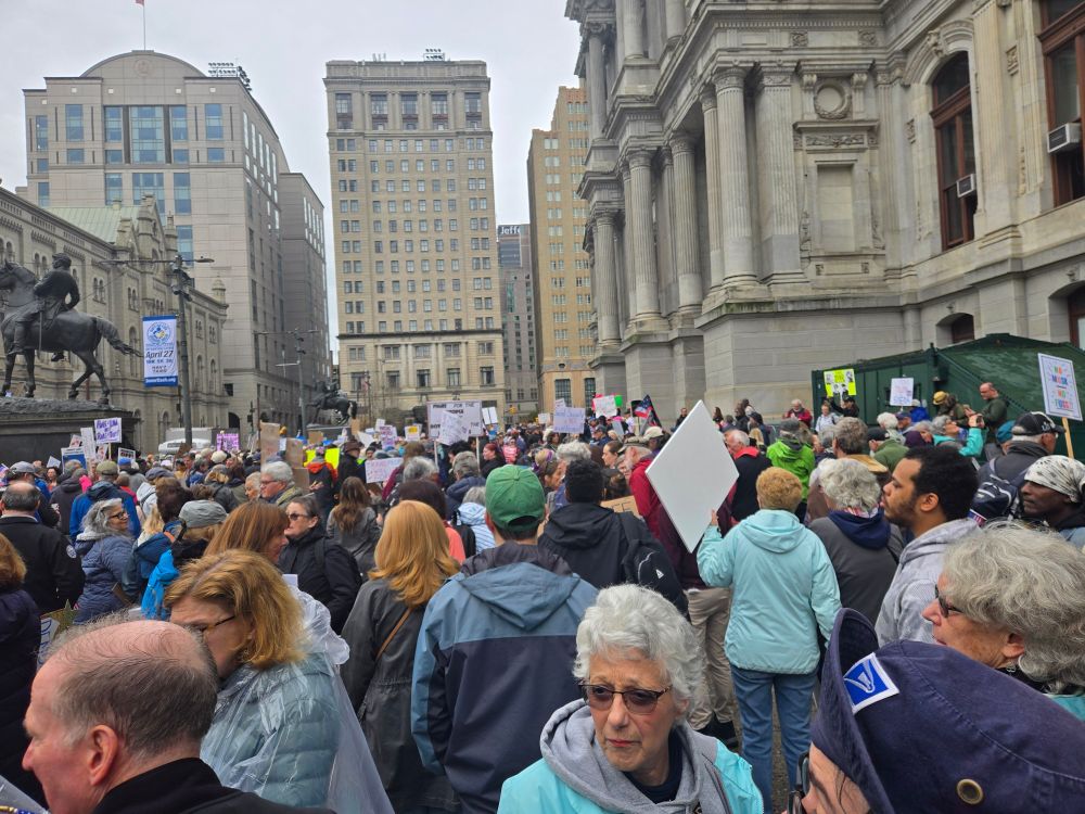 Photo from Philly Hands Off protest featuring crowds and signs in front of City Hall.