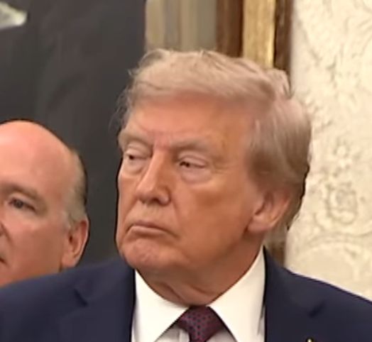 Screengrab from Trump presser showing very blotchy makeup and a visible line over his brow