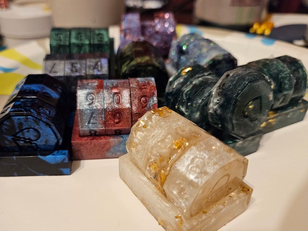 A pile of Cleric's Components resin life counters, waiting to be sanded and painted