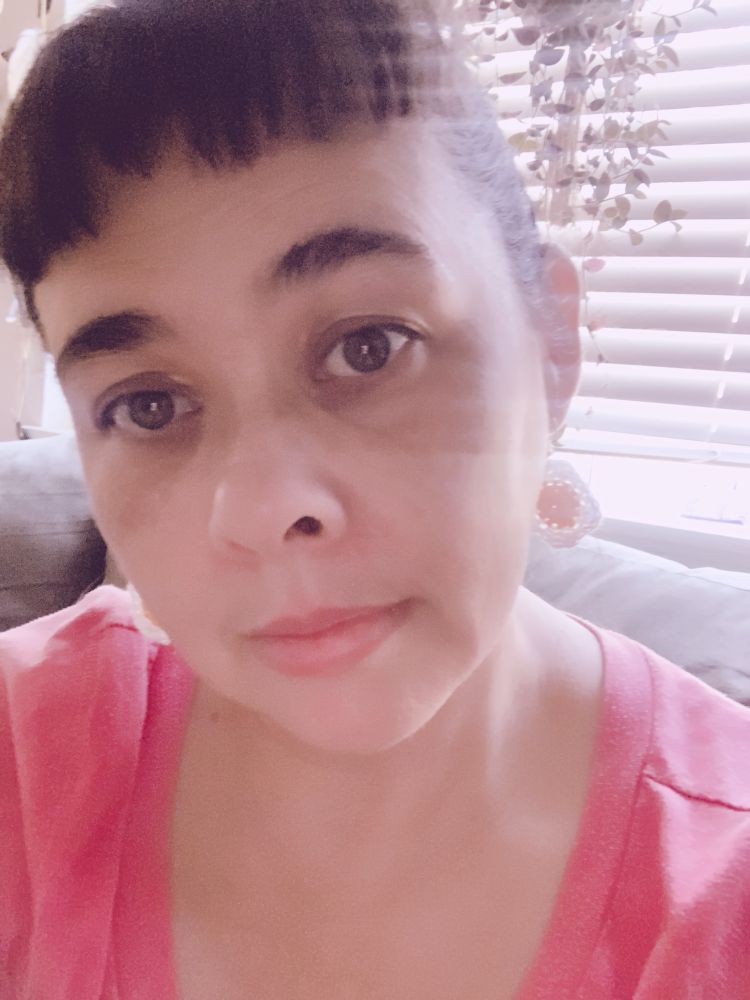 Me showing off my sunny side up earrings while being too tired to live