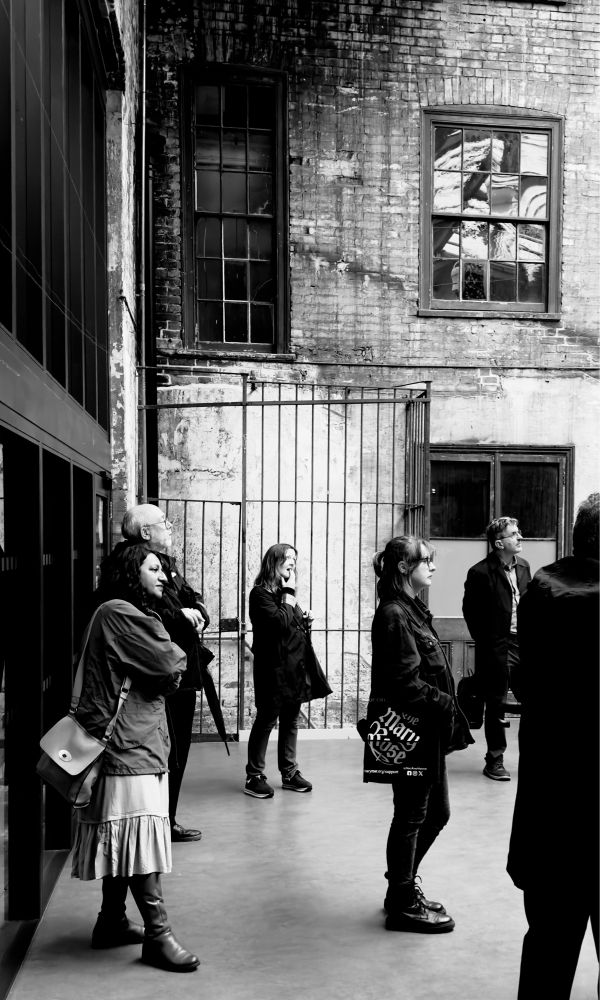 People standing in a Victorian metalwork yard at Treadgolds in Portsmouth UK